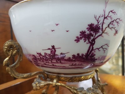 26768048d - Magnificent bowl on a bronze stand, Meissen, painting probably Bonaventura Gottlieb Häuer, around 1745/50, porcelain, camaieu painting in purple, pastoral landscape all around, inside base with picture cartouche, masterly depth perspective, gold edges, gold-plated bronze fittings, mouth edge restored, D. 15.5 cm, slight traces of age
