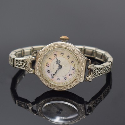 Image 26768675 - WALTHAM white gold-Filled wristwatch model Sapphire, manual winding, USA around 1930, partial engine-turned dial with mother-of- pearl inlay marked Shield, hinge case, case back with monogram, case lavish engraved, lavish pierced and engraved stretch-bracelet with case lock, compensation-balance with Breguet-hairspring, pressed chatons, diameter approx. 27 mm, length approx. 16,5 cm, condition 2-3