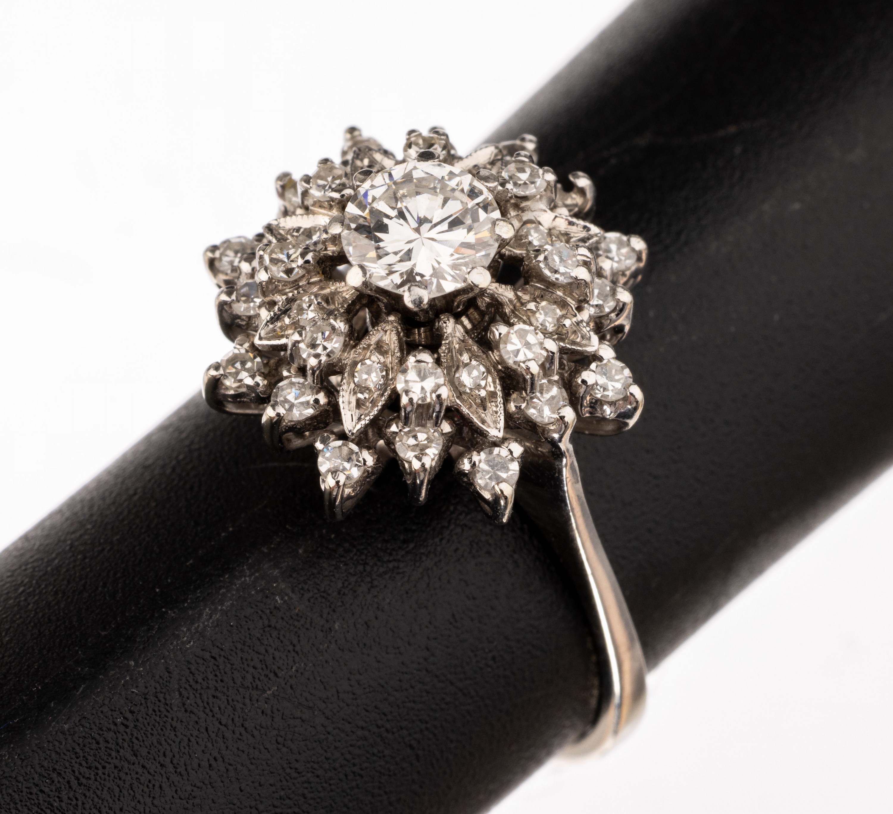 14 kt Gold Diamant-Ring, WG 585/000 gepr., Ringkopf in mehreren Ebenen, mittig erhaben gefasster Brillant ca. 0.40 ct Weiß/si, umgeben von 31 ...
