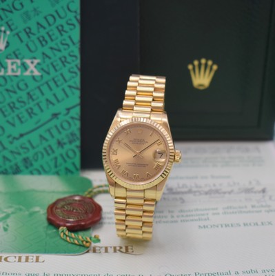 Image 26768951 - ROLEX Datejust medium wristwatch reference 78278, self winding, LC 100, A-series, superlative chronometer officially certified, 18k yellow gold including president bracelet with deployant clasp, gilded dial with Roman hour-indices, date under sapphire crystal with magnifying glass at 3, rhodium plated movement calibre 2235, 31 jewels, 5 adjustments, diameter approx. 31 mm, length approx. 18,5 cm, original box and papers, sold in March 2002, signs of use, condition 2