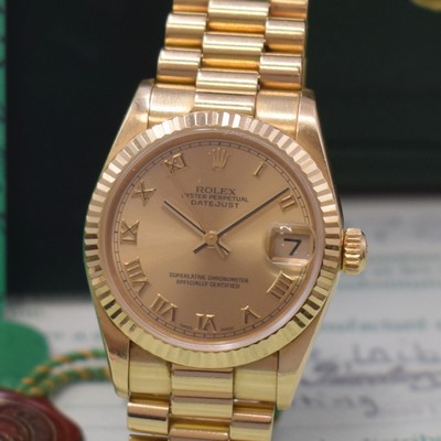 26768951a - ROLEX Datejust medium wristwatch reference 78278, self winding, LC 100, A-series, superlative chronometer officially certified, 18k yellow gold including president bracelet with deployant clasp, gilded dial with Roman hour-indices, date under sapphire crystal with magnifying glass at 3, rhodium plated movement calibre 2235, 31 jewels, 5 adjustments, diameter approx. 31 mm, length approx. 18,5 cm, original box and papers, sold in March 2002, signs of use, condition 2