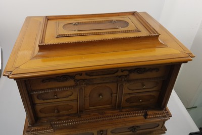 26769341a - Model cabinet cupboard, South German, 18th century, oak veneer, lid with drawer, behind it a lock for the lid drawer, old lock and fittings, former 2-door front is missing, 6 drawers, Renaissance decor, drawers mainly lined with marble paper, restored, 4 secondary feet, 29x36x26 cm, 1 key available