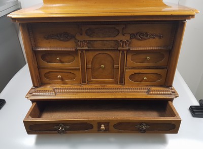 26769341i - Model cabinet cupboard, South German, 18th century, oak veneer, lid with drawer, behind it a lock for the lid drawer, old lock and fittings, former 2-door front is missing, 6 drawers, Renaissance decor, drawers mainly lined with marble paper, restored, 4 secondary feet, 29x36x26 cm, 1 key available
