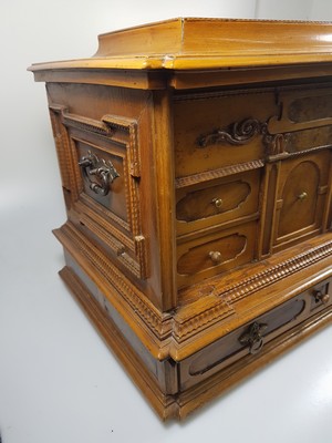 26769341m - Model cabinet cupboard, South German, 18th century, oak veneer, lid with drawer, behind it a lock for the lid drawer, old lock and fittings, former 2-door front is missing, 6 drawers, Renaissance decor, drawers mainly lined with marble paper, restored, 4 secondary feet, 29x36x26 cm, 1 key available