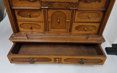 26769341p - Model cabinet cupboard, South German, 18th century, oak veneer, lid with drawer, behind it a lock for the lid drawer, old lock and fittings, former 2-door front is missing, 6 drawers, Renaissance decor, drawers mainly lined with marble paper, restored, 4 secondary feet, 29x36x26 cm, 1 key available