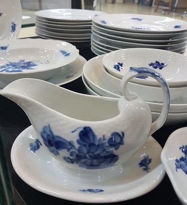 26773884d - Dining service, Kgl. Copenhagen, porcelain, basket-like relief rim, blue flower painting under the glaze, 16 flat plates, 17 deep plates, 4 soup bowls with saucers, 2 round side dishes, 2 round bowls, gravy boat, mustard pot, rectangular bowl, 2 candlesticks, traces of usage