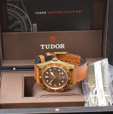 26774221e - TUDOR Armbandchronometer Black Bay bronze reference 79250B, self winding, case back and winding crown screwed down, waterproof from manufacturing, original leather strap with buckle, unidirectional revolving bezel, brown dial with luminous-indices, luminous hands, display of hour, minutes and sweep seconds, diameter approx. 43 mm, original box, description and additional textile strap enclosed, condition 2