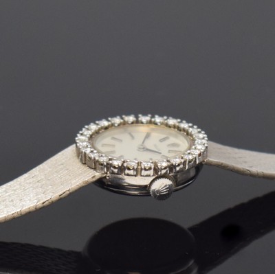 26774554d - ROLEX 18k white gold and diamonds set ladies wristwatch, Switzerland 1960´s, manual winding, snap on case back, original gold bracelet, bezel lavish set with diamonds, silvered dial with raised hour-indices, black hands, calibre 1400, 18 jewels, diameter approx. 23 mm, length approx. 17 cm, total weight approx. 45g, glass damaged, overhaul recommended at buyer's expense, condition 2