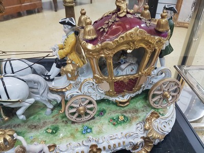 26776716b - Large four-horse rococo carriage, Unterweißbach, Thuringia, 20th century, designed by Kurt Steiner (1904-1970), porcelain, polychrome painted, rich gold decoration, coachman, pillion passenger and noble lady with tulle lace dress inside, base with shellwork decoration, floor mark, 31x80x33 cm, traces of age