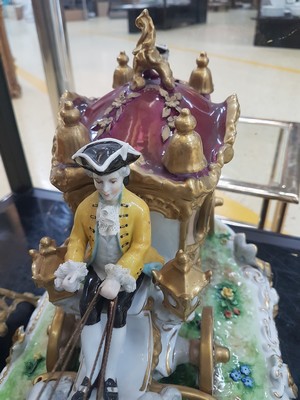 26776716j - Large four-horse rococo carriage, Unterweißbach, Thuringia, 20th century, designed by Kurt Steiner (1904-1970), porcelain, polychrome painted, rich gold decoration, coachman, pillion passenger and noble lady with tulle lace dress inside, base with shellwork decoration, floor mark, 31x80x33 cm, traces of age