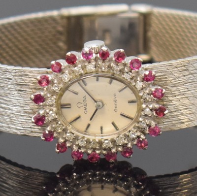 26777848a - OMEGA 14k white gold ladies wristwatch with diamonds and rubies, Switzerland around 1970, manual winding, case with gold bracelet, snap on case back, bezel with rubies and diamonds, silvered dial with applied hour-indices, black hands, copper coloured movement calibre 485, 17 jewels, diameter approx. 21 mm, length approx. 15,5 cm, total-weight approx. 34g, overhaul recommended at buyer's expense, condition 2