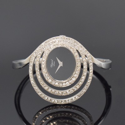 Image 26777850 - CHOPARD unusual and rare 18k white gold and diamonds set ladies wristwatch, Switzerland around 1980, manual winding, oval case, snap on case back, clasp, onyx-dial with silvered hands, measures approx. 41 x 34 mm, for arm circumference approx. 5 x 4,5 cm, overhaul recommended at buyer's expense, condition 2