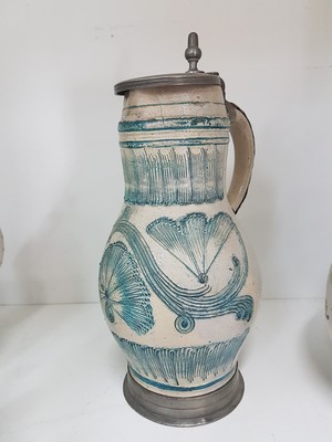 26778677d - Seven jugs, German, 18th century, mostly faience, roller jugs with tin lids, painted, one jug slightly Chipped, a jug with a crack, two pear jugs, decor nobleman with bottle, height approx. 15.5 cm, jug with tin lid and toast, height 16 cm, small pear shaped jug with pewter lid, height 16 cm, pear shaped jug with bouquet of flowers, height 22 cm, l. best.; Stoneware jug , vegetal incised decoration, pewter lid, height 29 cm, all parts with slight Age damage or signs of age