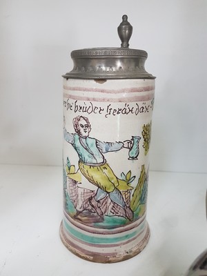 26778677i - Seven jugs, German, 18th century, mostly faience, roller jugs with tin lids, painted, one jug slightly Chipped, a jug with a crack, two pear jugs, decor nobleman with bottle, height approx. 15.5 cm, jug with tin lid and toast, height 16 cm, small pear shaped jug with pewter lid, height 16 cm, pear shaped jug with bouquet of flowers, height 22 cm, l. best.; Stoneware jug , vegetal incised decoration, pewter lid, height 29 cm, all parts with slight Age damage or signs of age