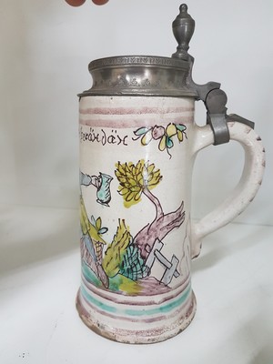 26778677j - Seven jugs, German, 18th century, mostly faience, roller jugs with tin lids, painted, one jug slightly Chipped, a jug with a crack, two pear jugs, decor nobleman with bottle, height approx. 15.5 cm, jug with tin lid and toast, height 16 cm, small pear shaped jug with pewter lid, height 16 cm, pear shaped jug with bouquet of flowers, height 22 cm, l. best.; Stoneware jug , vegetal incised decoration, pewter lid, height 29 cm, all parts with slight Age damage or signs of age