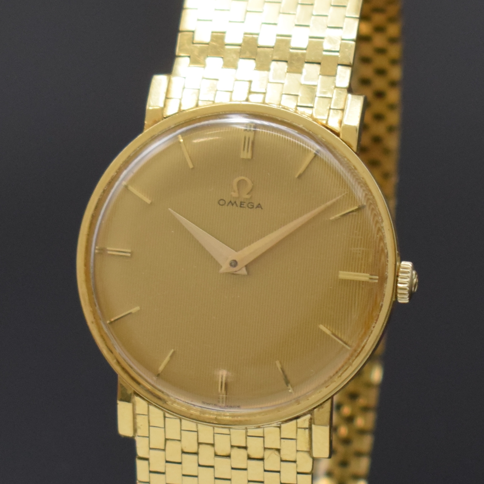 Detail a: OMEGA Herrenarmbanduhr in GG 750/000 Referenz 14372, Schweiz um 1958, Handaufzug, Boden und Glasrand aufgedr., neutr. Backsteinband in GG 750/000 l. ...