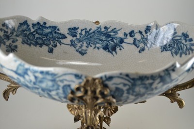 26778700d - Offering bowl, German, end of the 19th century, navette-shaped faience bowl, underglaze blue floral decoration inside and outside, bronze fittings in the Renaissance style, base with masquerades, double handle formed from a pair of swans, 30x44x18 cm, unidentified bottom mark, traces of age