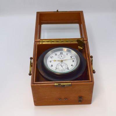 Image 26779817 - WEMPE / JOHN SCHWARZER number 2800 rare Air- Force surface chronometer with lever escapement, Germany around 1942, two piece construction wooden box, removable upper part bevelled-glazed, inside suspended aluminum- case in rubber-suspension, blacked out, at the sides hand-setting and second-stop, slave clock-port controlled by second-contact, white dial signed John Schwarzer, 56-hour-power reserve indicator at 12, constant second at 6, original hands, lever chronometer on basic of the "Einheits"-chronometer, chain and fusee, chronometer-balance with cylindric hairspring, 13 jewels, unusual second-contact, measures approx. 19 x 19 x 17 cm, condition 2-3 John Schwarzer was an outstanding staff-member of the development department from Wempe. The "Einheits"-chronometer starts with number 2800. The present watch is the first produced. Property of a collector . The numbering of the "Einheits"-chronometer starts with the number 2800. The present watch is the first produced.