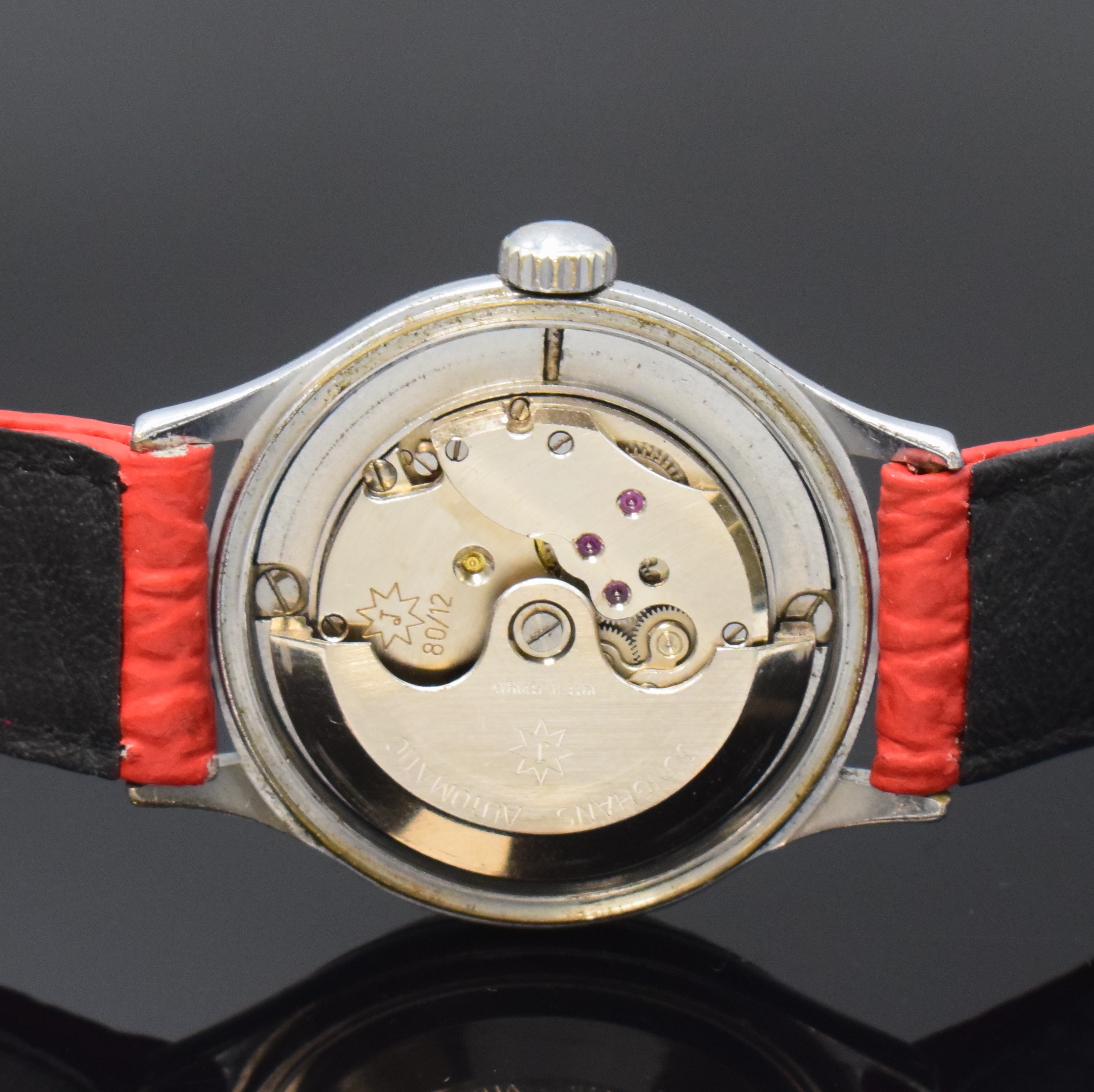 Detail d: JUNGHANS Automatik Armbanduhr mit Gangreserveanzeige Kaliber 80/12, Deutschland um 1952, 2-tlg. verchr. Geh. m. verschr. Stahlboden, schwarzes ...