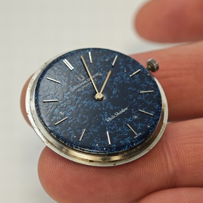 26779949f - UNIVERSAL White Shadow thin self winding- wristwatch reference 866101/05 in steel, Switzerland around 1968, two piece construction case, snap on case back, original winding crown, blue marbled dial with hairline cracks (so called "Spiderweb"), applied silvered indices, silvered hands, micro-rotor-movement calibre 1-66 with fausses cotes decoration, 25 jewels, diameter approx. 35 mm, overhaul recommended at buyer's expense, condition 2, property of a collector
