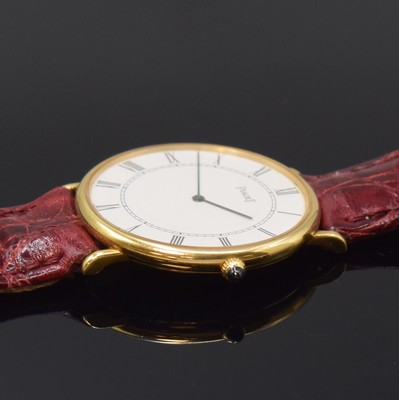26780055b - PIAGET 18k yellow gold reference 9035 thin and elegant wristwatch, Switzerland around 1970, manual winding, two piece construction case, snap on case back, white dial patinated, fine Roman numerals, line hands, silvered movement calibre 9P2 with fausses cotes decoration, 18 jewels, 5 adjustments, diameter approx. 32,5 mm, needs to be overhauled, condition 2-3, property of a collector