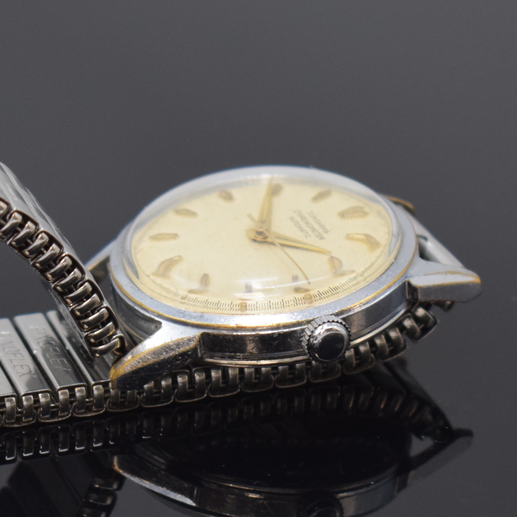 Detail b: JUNGHANS Chronometer Kaliber 83 verchromte Herrenarmbanduhr, Deutschland um 1960, Automatik, Geh. m. aufgedr. Stahlboden, Flexband, silb. Zifferbl. ...