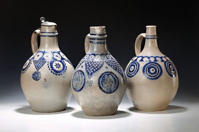 Image 26781215 - Three serving jugs/jugs, Westerwald, 18th century, stoneware, with incised decoration and blue painting, one with a tin lid (dented), one with a hairline crack on the spout, height approx. 36-39 cm