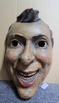 26781752e - Three masks, Swiss/Alemannic, 19th and 20th centuries, carved wood, a. distorted face with wart, approx. 28 x 19 cm, crack; b. Mask with movable jaw and hair, approx. 25 x 24 cm; c. Mask, young man, height approx. 25 cm