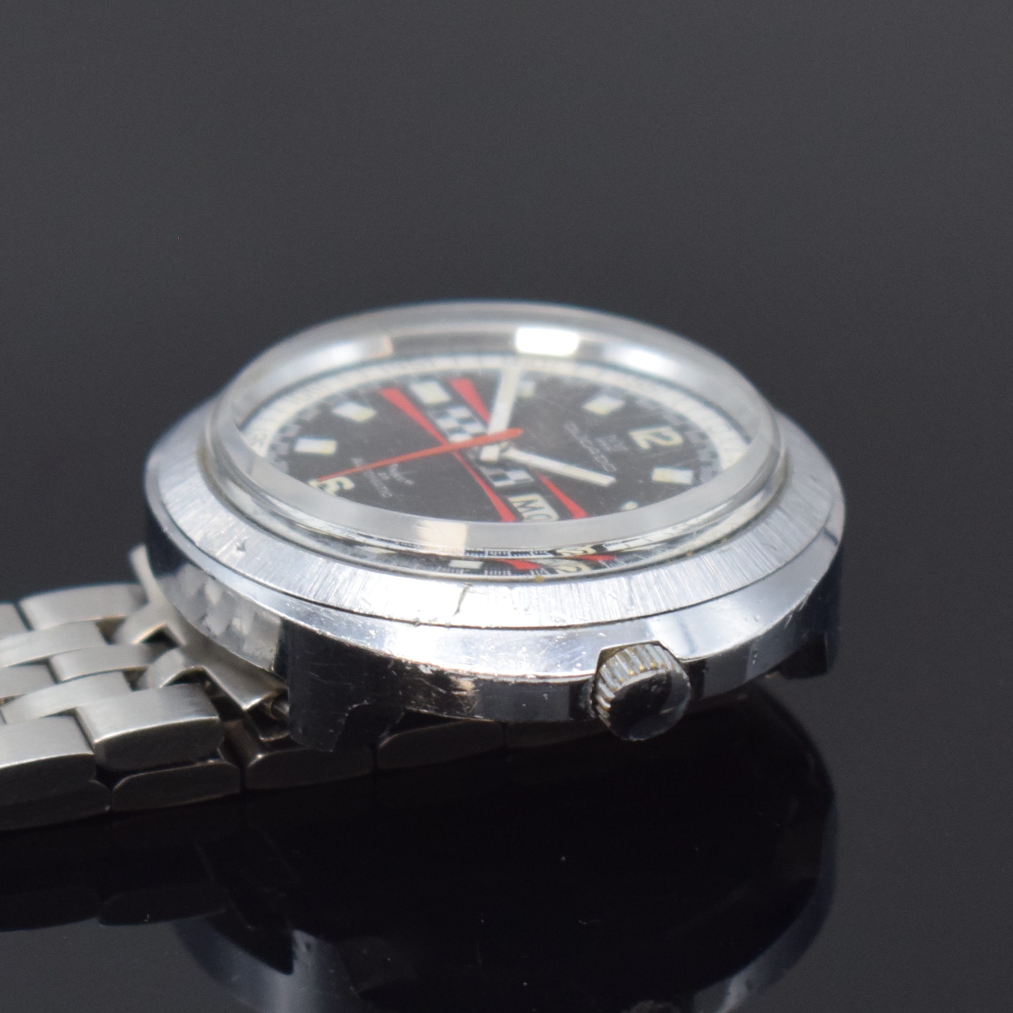 Detail c: DUCADO verchromte Herrenarmbanduhr, Schweiz um 1975, Automatik, orig. Gliederband m. Faltschl., Stahlboden aufgedr., schwarzes Zifferbl. m. ...