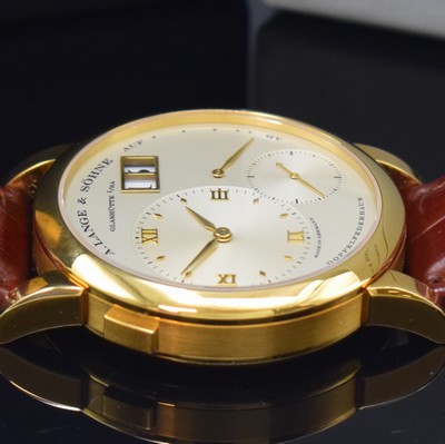 26783108c - A. LANGE & SÖHNE very rare & early Lange 1 reference 101.001 in 18k yellow gold, manual winding, solid gold back 6-times screwed, silvered dial, applied gilded indices, separate dials for hours/minutes, second, power reserve indicator and big date, gilded alpha hands, nickel silver movement calibre 901.0, Glashutter stripe, 53 jewels, 9 screwed down gold chatons, Glucydur-balance with Breguet-hairspring, in 5 Lagen reguliert, original leather strap with original 18k yellow gold buckle, diameter approx. 38,5 mm, original box, Hangtag and papers enclosed, condition 2