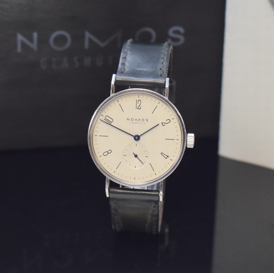 Image 26783436 - NOMOS Glashütte Tangente 'Expo 2000' to 2000 pieces limited wristwatch in steel, Germany sold according to warranty in September 1998, manual winding, on both sides glazed case including original leather strap with buckle, snap on case back and bezel, cream colored dial with Arabic numerals and line-indices, blued steel hands, calibre ETA 7001, 17 jewels, blued screws, diameter approx. 35 mm, original box and warranty enclosed, condition 2