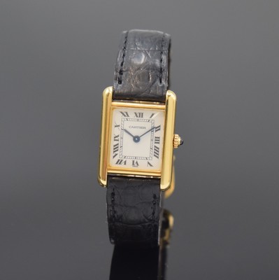 Image 26783440 - CARTIER Paris 18k yellow gold Tank wristwatch, Switzerland around 1990, quartz, case at the sides 4-times screwed down, original leather strap with gold-plated deployant clasp, jeweled crown, white dial with Roman numerals, blued steel hands, measures approx. 28 x 21 mm, condition 2-3