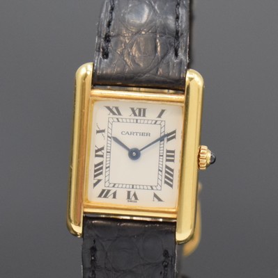 26783440a - CARTIER Paris 18k yellow gold Tank wristwatch, Switzerland around 1990, quartz, case at the sides 4-times screwed down, original leather strap with gold-plated deployant clasp, jeweled crown, white dial with Roman numerals, blued steel hands, measures approx. 28 x 21 mm, condition 2-3