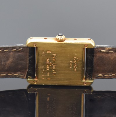 26783440c - CARTIER Paris 18k yellow gold Tank wristwatch, Switzerland around 1990, quartz, case at the sides 4-times screwed down, original leather strap with gold-plated deployant clasp, jeweled crown, white dial with Roman numerals, blued steel hands, measures approx. 28 x 21 mm, condition 2-3