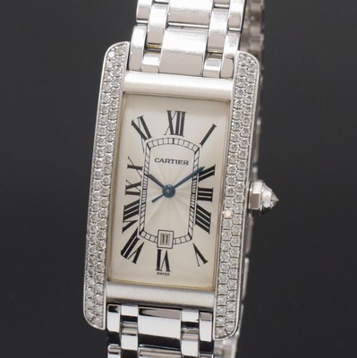26783870a - CARTIER 18k white gold and factory diamonds set wristwatch Tank Americaine reference 1726, self winding, Switzerland around 1995, original bracelet with butterfly buckle, back with 8 screws, silvered, engine-turned dial with Roman hours, blued steel hands, display of hours, minutes, sweep seconds and date, Diamantkrone, rhodium plated movement, 25 jewels, calibre 077 with fausses cotes decoration, measures approx. 42 x 23 mm, length approx. 19,5 cm, weight approx. 129g, condition 2-3