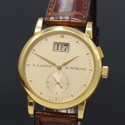 26784406a - A. LANGE & SÖHNE 18k yellow gold wristwatch Saxonia reference 105.021, manual winding, Germany around 2000, on both sides glazed case including original leather strap with original 18k yellow gold buckle, case back 6- times screwed, correction for date at 2, silvered dial, big date at 12, constant second at 6, blued steel hands, nickel silver movement calibre 941.3 with fausses cotes decoration, 30 jewels, 4 screwed down gold chatons, 5 adjustments, precision adjustment, diameter approx. 34 mm, condition 2