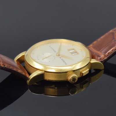 26784406d - A. LANGE & SÖHNE 18k yellow gold wristwatch Saxonia reference 105.021, manual winding, Germany around 2000, on both sides glazed case including original leather strap with original 18k yellow gold buckle, case back 6- times screwed, correction for date at 2, silvered dial, big date at 12, constant second at 6, blued steel hands, nickel silver movement calibre 941.3 with fausses cotes decoration, 30 jewels, 4 screwed down gold chatons, 5 adjustments, precision adjustment, diameter approx. 34 mm, condition 2
