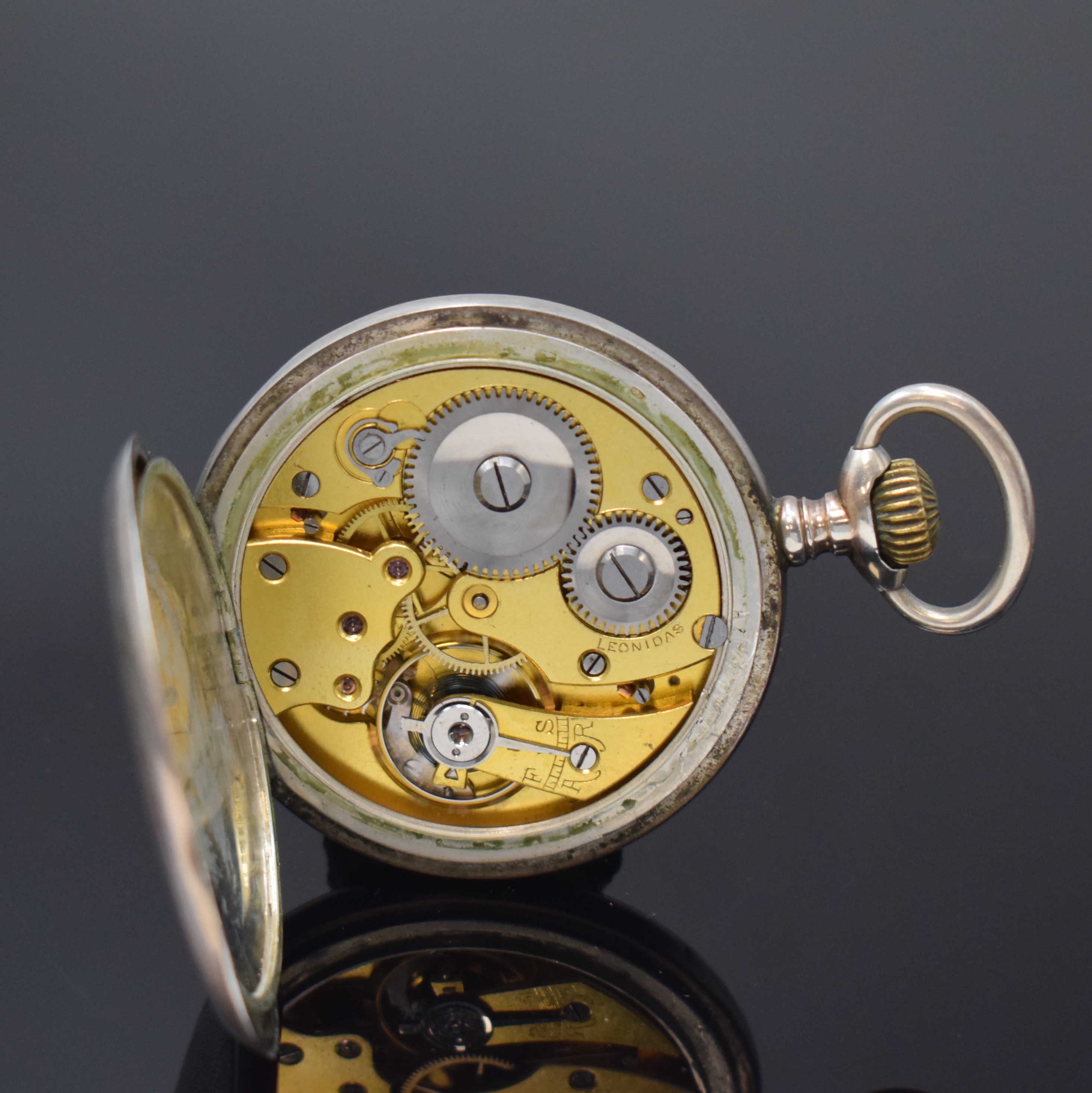 Detail j: Ausgefallener Uhrenständer in Form einer Dose mit Lupenglas und offener Silbertaschenuhr, Schweiz um 1890/1910, floral grav. Uhrenständer in Nickel ...