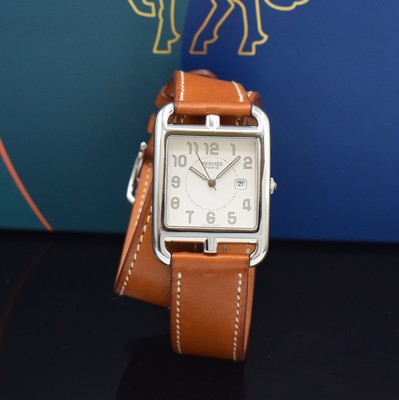 Image HERMES wristwatch series Cape Cod reference CC2.710, stainless steel case including original leather strap with original buckle, quartz, case back screwed-down 4-times, silvered dial with Arabic hour, display of hour, minutes, sweep seconds & date, measures approx. 41 x 29 mm, Hermes storage back enclosed, unworn stock, condition 1-2