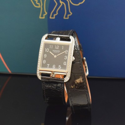 Image HERMES wristwatch series Cape Cod reference CC3.730, quartz, stainless steel case including original leather strap with , original buckle, case back screwed-down 4- times, case at the sides with diamonds, black dial with Arabic numerals, silvered hands, measures approx. 40,5 x 29 mm, Hermes storage back enclosed, unworn stock, condition 1-2