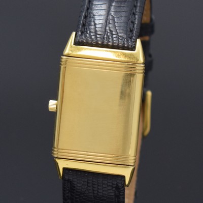 26786819c - Jaeger-LeCoultre Reverso 18k yellow gold wristwatch, Switzerland around 1995, quartz, around 180 degree revolving reverse case, at the sides screwed down, cream colored dial with Arabic numerals, blued steel hands, date at 6, measures approx. 40 x 23 mm, case number as well as reference number not visible anymore, signs of use, condition 2-3