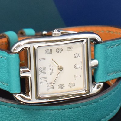 26787163a - HERMES ladies wristwatch series Cape Cod reference CC1.210a, stainless steel case including original leather strap with original buckle, quartz, case back 4-times screwed down, white dial Arabic hour, measures approx. 33 x 23 mm, Hermes storage back enclosed, unworn stock, condition 1-2