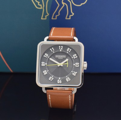 Image HERMES wristwatch series Carre H reference TI2.710, self winding, stainless steel case including original leather strap with original buckle, on both sides glazed, case back screwed-down 4-times, gray dial with Arabic hour, display of hour, minutes & central second, diameter approx. 38 mm, Hermes storage back enclosed, unworn stock, condition 1-2