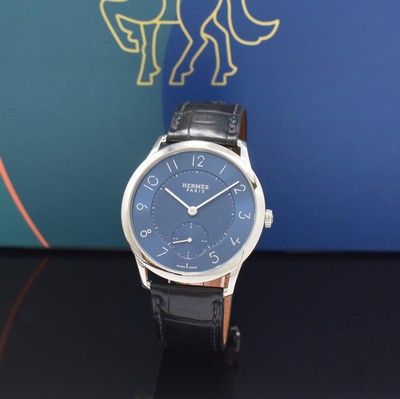 Image HERMES wristwatch series Slim d´Hermes reference CA2.810, self winding, stainless steel case including original leather strap with original buckle, on both sides glazed, case back screwed-down 4-times, blue, in center engine-turned dial, display of hour, minutes & constant second, diameter approx. 40 mm, Hermes storage back enclosed, unworn stock, condition 1-2