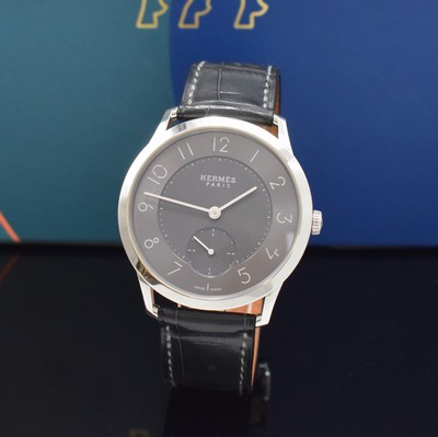 Image HERMES wristwatch series Slim d´Hermes reference CA2.810, self winding, stainless steel case including original leather strap with original buckle, on both sides glazed, case back screwed-down 4-times, gray, in center engine-turned dial, display of hour, minutes & constant second, diameter approx. 40 mm, Hermes storage back enclosed, unworn stock, condition 1-2