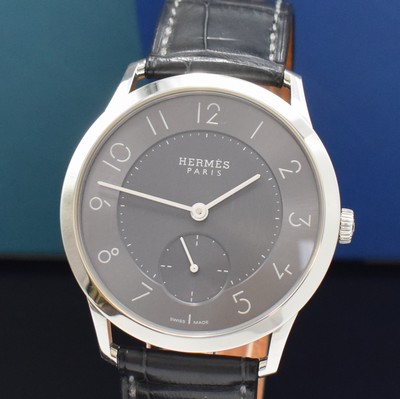 26787184a - HERMES wristwatch series Slim d´Hermes reference CA2.810, self winding, stainless steel case including original leather strap with original buckle, on both sides glazed, case back screwed-down 4-times, gray, in center engine-turned dial, display of hour, minutes & constant second, diameter approx. 40 mm, Hermes storage back enclosed, unworn stock, condition 1-2