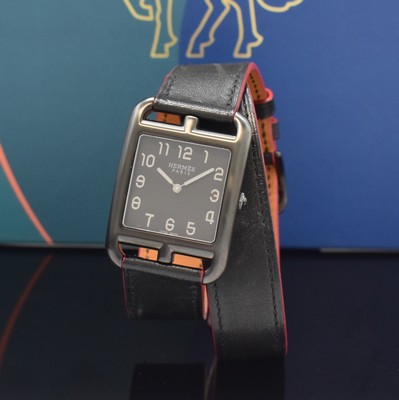 Image HERMES wristwatch series Cape Cod reference CC3.711, quartz, blackened stainless steel case including original leather strap with original buckle, case back screwed-down 4- times, black dial with Arabic numerals, silvered hands, measures approx. 41 x 29 mm, Hermes storage back enclosed, unworn stock, condition 1-2