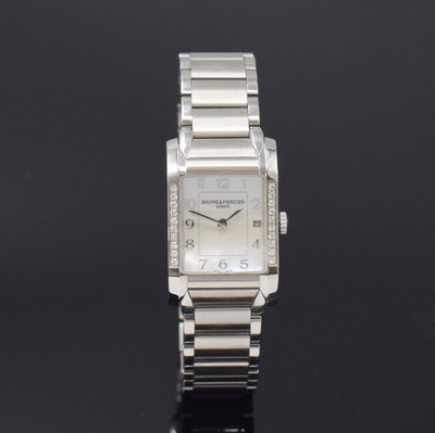 Image 26787938 - BAUME & MERCIER ladies wristwatch series Hampton reference 65725, quartz, stainless steel case including bracelet with butterfly buckle, bezel at the sides diamonds set, mother of pearl dial with raised Arabic hours, display of hours, minutes & date, measures approx. 34 x 22 mm, length approx. 18,5 cm, condition 2