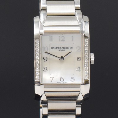 26787938a - BAUME & MERCIER ladies wristwatch series Hampton reference 65725, quartz, stainless steel case including bracelet with butterfly buckle, bezel at the sides diamonds set, mother of pearl dial with raised Arabic hours, display of hours, minutes & date, measures approx. 34 x 22 mm, length approx. 18,5 cm, condition 2
