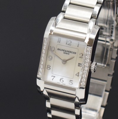 26787938c - BAUME & MERCIER ladies wristwatch series Hampton reference 65725, quartz, stainless steel case including bracelet with butterfly buckle, bezel at the sides diamonds set, mother of pearl dial with raised Arabic hours, display of hours, minutes & date, measures approx. 34 x 22 mm, length approx. 18,5 cm, condition 2